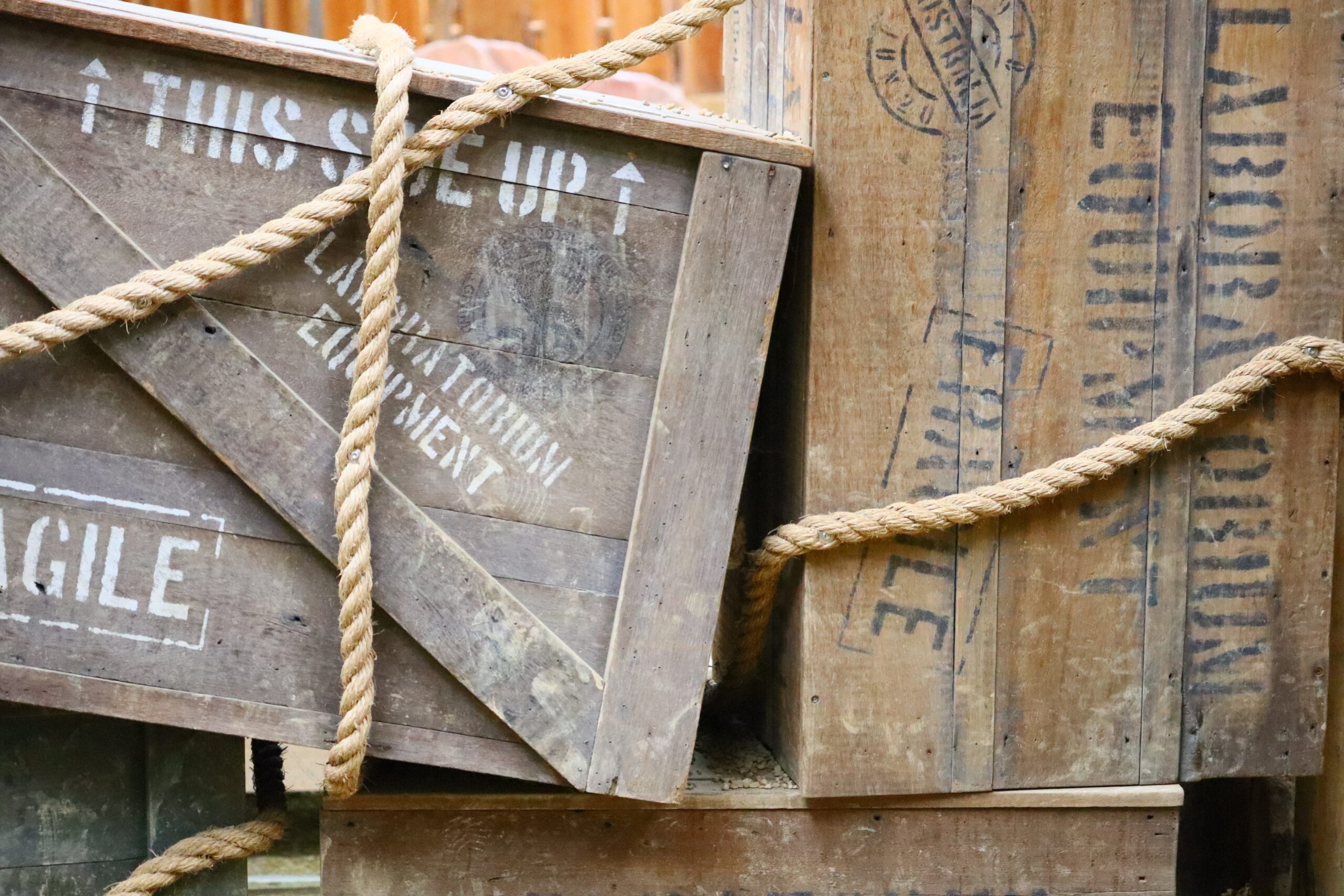 A wooden box with text written on them and ropes around them